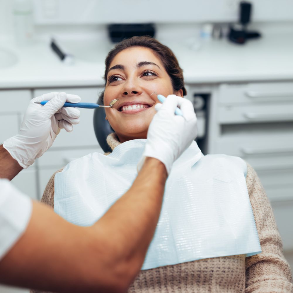 Woman smiling during dental checkup examination by Dr. Theodora Bravis at Thames Dental & Skin clinic in Thames Ditton, Surrey