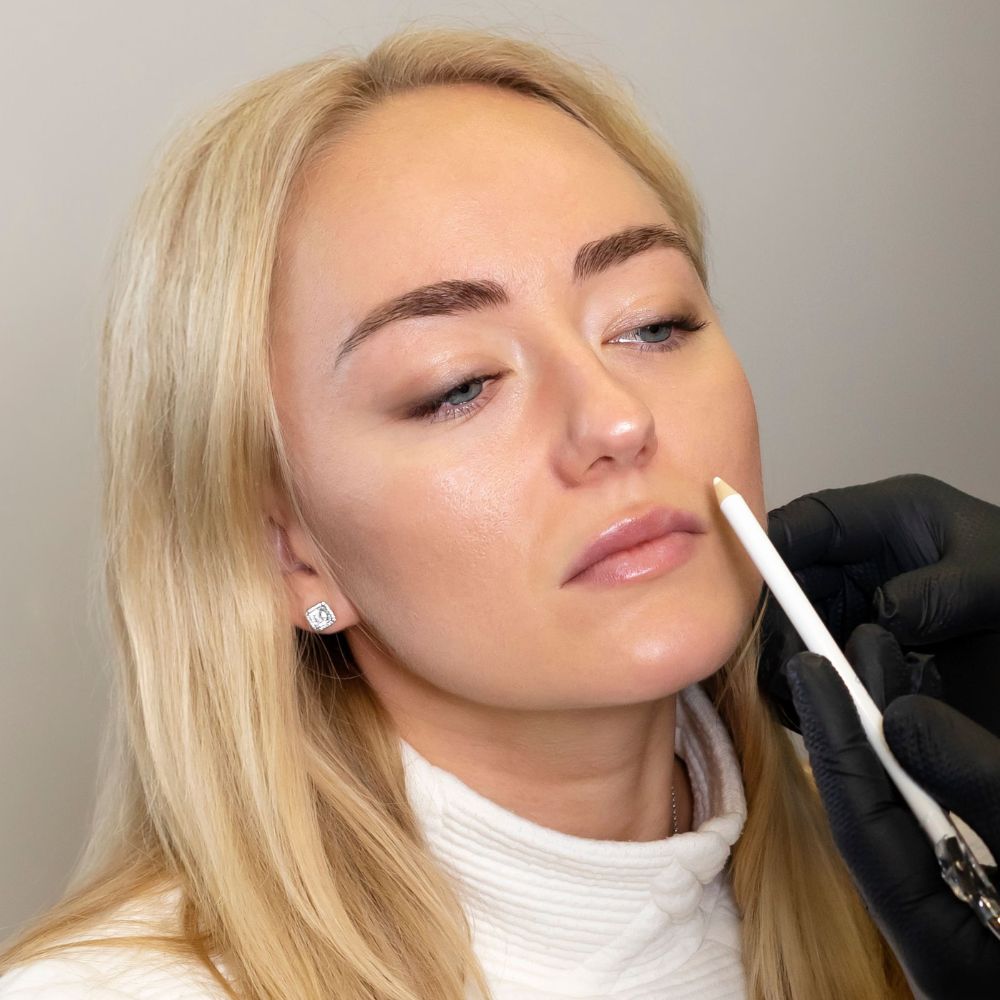 Dr Theodora Bravis discussing lip filler treatment with a patient at Thames Dental and Skin in Thames Ditton in Surrey