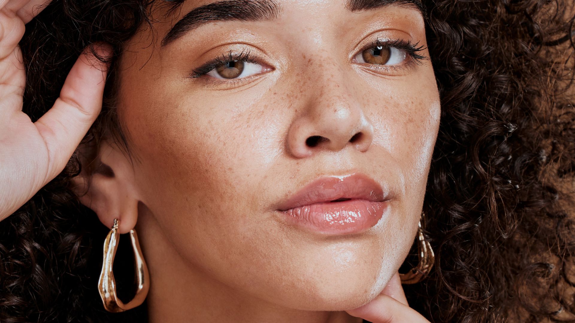 A radiant black woman displaying her flawless, even complexion after undergoing advanced skin and facial aesthetic treatments at Thames Dental and Skin Clinic in Thames Ditton, Surrey, performed by the skilled Dr Theodora Bravis, demonstrating the clinic's commitment to helping patients achieve their best skin and overall appearance.