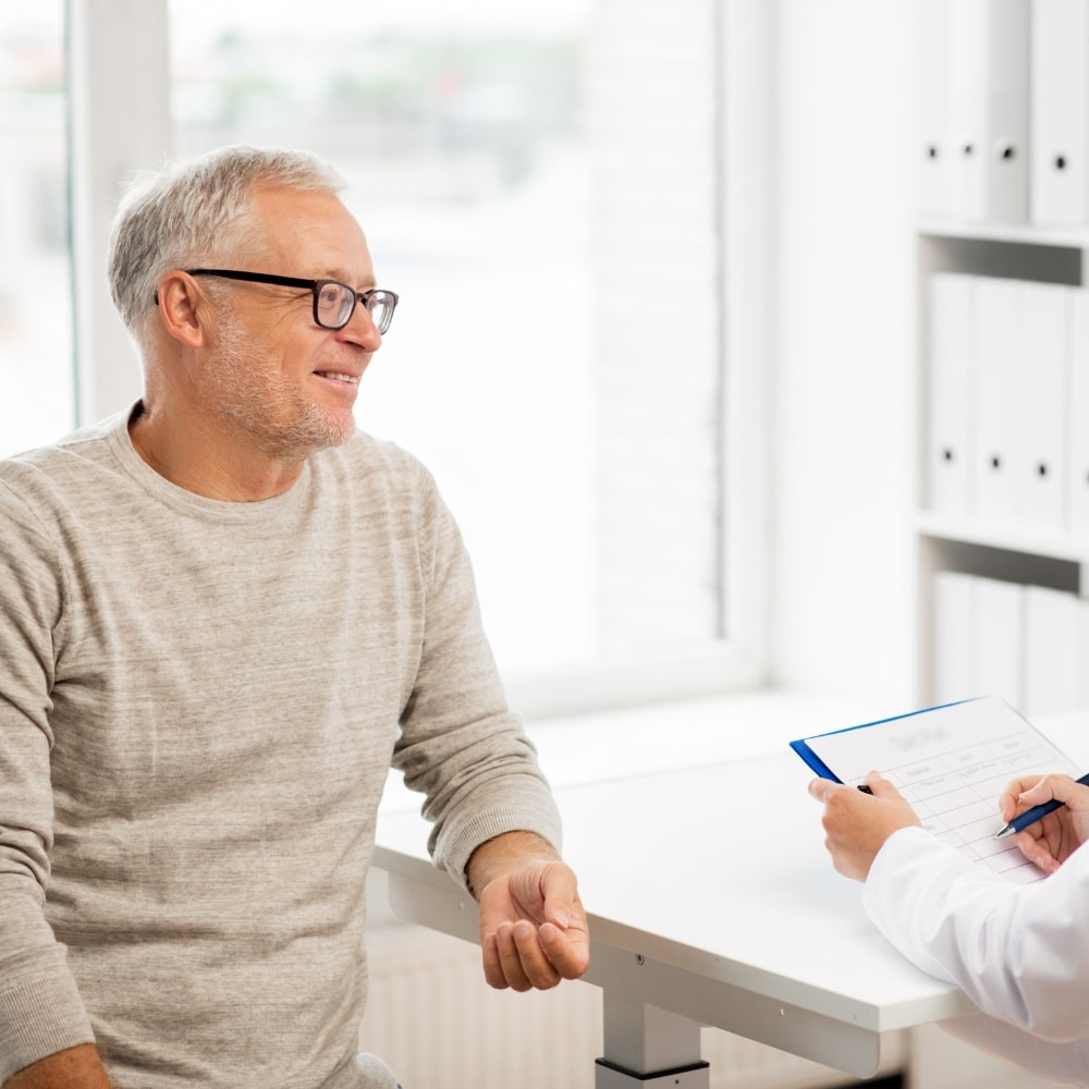 male patient receiving a health and wellness consultation from Dr. Bravis at Thames Dental & Skin Clinic in Thames Ditton.