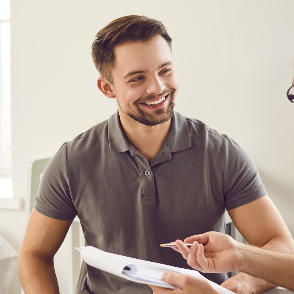 male patient receiving a health and wellness consultation from Dr. Bravis at Thames Dental & Skin Clinic in Thames Ditton.