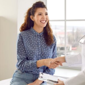 Female patient receiving a health and wellness consultation from Dr. Bravis at Thames Dental & Skin Clinic in Thames Ditton.